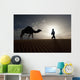 Silhouette Of Berber Leading Camel Across Sand Dunes At Dusk Wall Mural