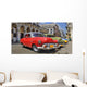 Havana street with colorful old cars in a raw Wall Mural