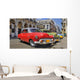 Havana street with colorful old cars in a raw Wall Mural