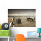 A Wooden Pier With Benches Looking Out Over The Beach And Water Wall Mural