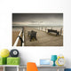 A Wooden Pier With Benches Looking Out Over The Beach And Water Wall Mural