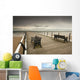 A Wooden Pier With Benches Looking Out Over The Beach And Water Wall Mural