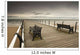 A Wooden Pier With Benches Looking Out Over The Beach And Water Wall Mural
