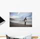 A Young Man Carries His Surfboard Down The Beach Wall Mural