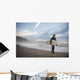 A Young Man Carries His Surfboard Down The Beach Wall Mural