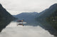 A Young Man Leaps Onto His Body Board In Cameron Lake Wall Mural