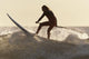 A Surfer Paddling On A Surfboard Off Benavides Beach Wall Mural