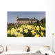 Yellow Daffodils In A Cemetery Beside A Church Wall Mural
