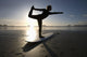 Silhouette Of Female Surfer Doing Bow Pulling Yoga Pose Wall Mural