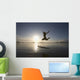 Silhouette Of Female Surfer Jumping For Joy Wall Mural