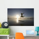 Silhouette Of Female Surfer Jumping For Joy Wall Mural