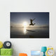 Silhouette Of Female Surfer Jumping For Joy Wall Mural