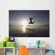 Silhouette Of Female Surfer Jumping For Joy Wall Mural