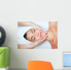 Beautiful young woman receiving facial massage. Wall Mural