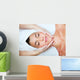 Beautiful young woman receiving facial massage. Wall Mural