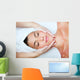 Beautiful young woman receiving facial massage. Wall Mural