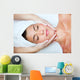 Beautiful young woman receiving facial massage. Wall Mural