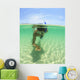 A Young Man Snorkels Holding A Starfish Underwater Wall Mural