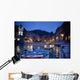 Boats Moored By Buildings Along The Waterfront At Night Wall Mural