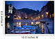 Boats Moored By Buildings Along The Waterfront At Night Wall Mural