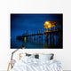 Lights On A Wooden Pier Leading Out In The Water At Night Wall Mural