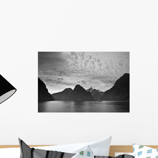 A Boat In The Water Along The Coast Surrounded By Mountains Wall Mural