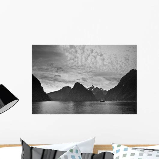 A Boat In The Water Along The Coast Surrounded By Mountains Wall Mural