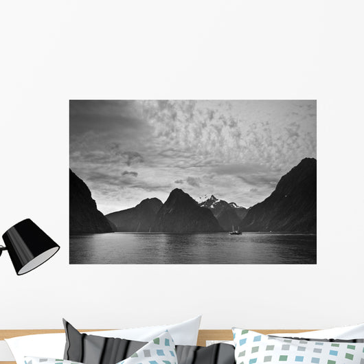 A Boat In The Water Along The Coast Surrounded By Mountains Wall Mural