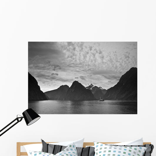 A Boat In The Water Along The Coast Surrounded By Mountains Wall Mural