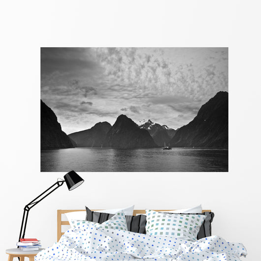 A Boat In The Water Along The Coast Surrounded By Mountains Wall Mural