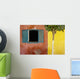 A Tree Outside A Colorful Building And A Window With Blue Shutters Wall Mural