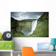 A Waterfall Over A Grassy Cliff Wall Mural