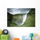 A Waterfall Over A Grassy Cliff Wall Mural