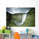 A Waterfall Over A Grassy Cliff Wall Mural