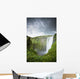 A Waterfall Over A Grassy Cliff Wall Mural