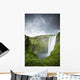 A Waterfall Over A Grassy Cliff Wall Mural