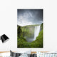 A Waterfall Over A Grassy Cliff Wall Mural