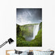 A Waterfall Over A Grassy Cliff Wall Mural