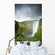 A Waterfall Over A Grassy Cliff Wall Mural