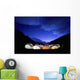 Tents Illuminated In A Valley At Night Wall Mural