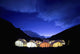 Tents Illuminated In A Valley At Night Wall Mural