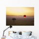 A Red Hot Air Balloon Takes Flight Against The Glowing Sky At Sunset Wall Mural