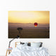 A Red Hot Air Balloon Takes Flight Against The Glowing Sky At Sunset Wall Mural