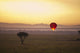 A Red Hot Air Balloon Takes Flight Against The Glowing Sky At Sunset Wall Mural