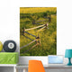 A Wooden Rail Fence Surrounded By Yellow Wildflowers Wall Mural