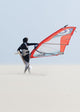 A Windsurfer Walks On The Sand Of Punta Paloma Beach With His Board Wall Mural