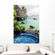 Jacuzzi and infinity pool over tropical ocean Wall Mural