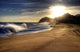 Wave on beach with sun shining. Wall Mural