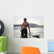 A Man Standing In The Water With His Surfboard Off Valdevaqueros Beach Wall Mural