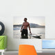 A Man Standing In The Water With His Surfboard Off Valdevaqueros Beach Wall Mural